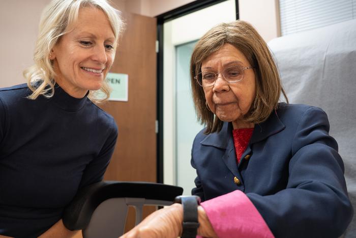 UC Davis Professor Sarah Tomaszewski Farias helps a study participant learn how to use the smartwatch.
