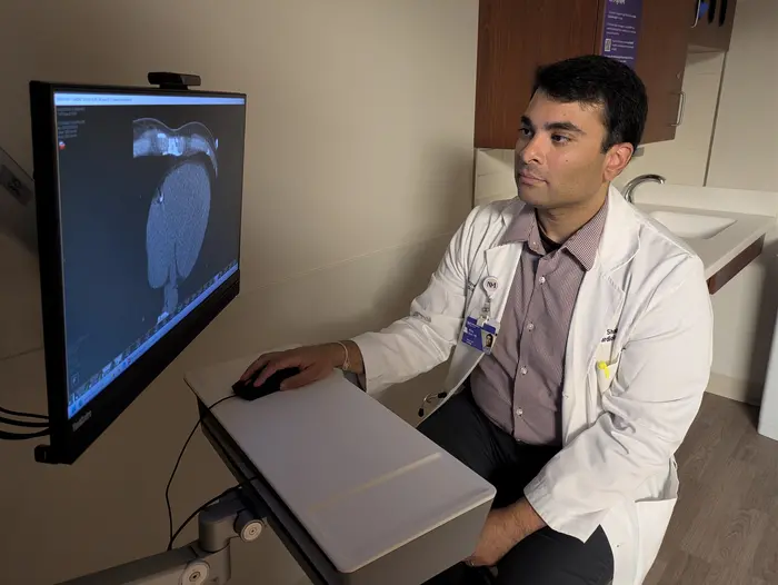 Study senior author Dr. Nilay Shah analyzes the coronary artery calcium scan of a patient