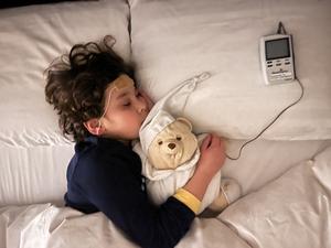 Sleeping child with trigeminal nerve stimulation device
