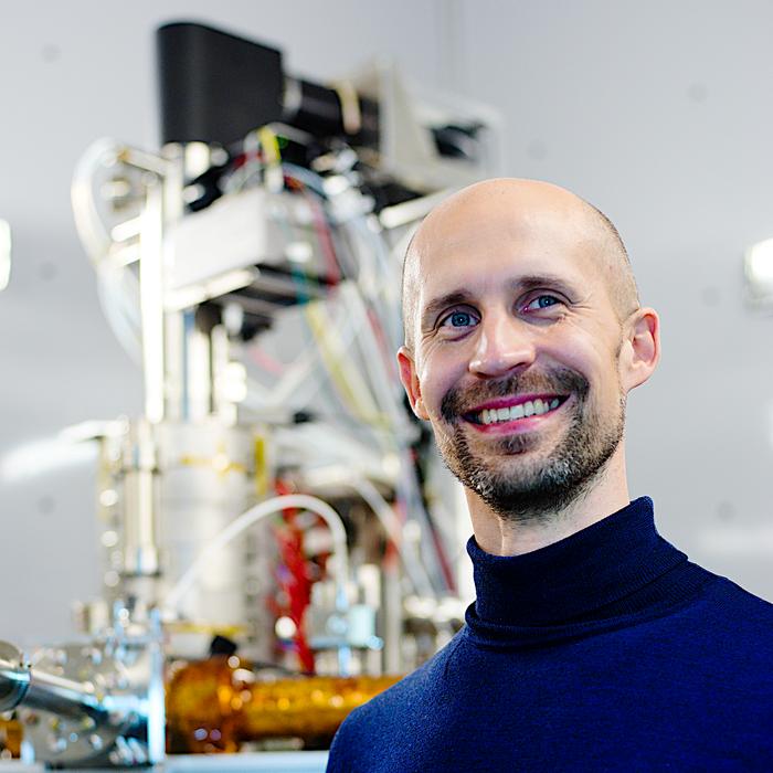 Fig. 2: Kimmo Mustonen in front of the Nion UltraSTEM 100 microscope used for the study.