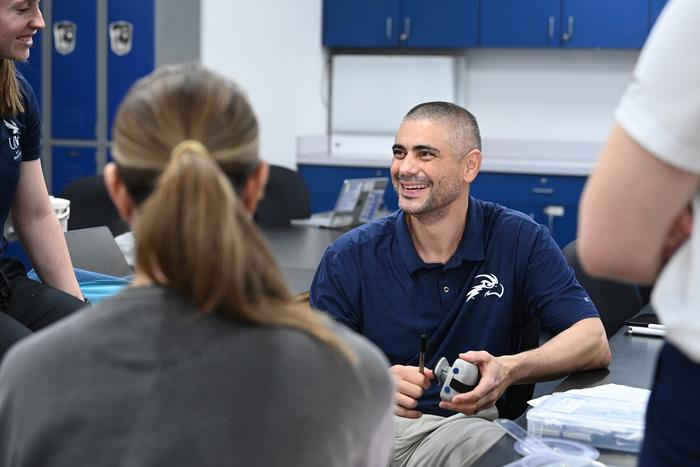 Dr. Gui Cesar talks with students