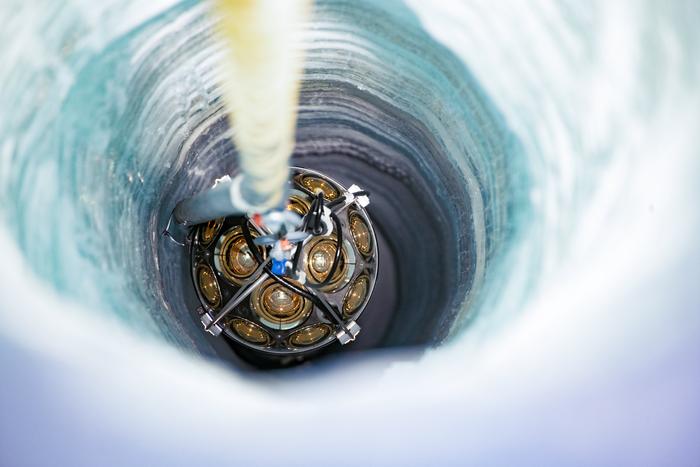 The chains with instruments are lowered into shafts drilled into the Antarctic ice.