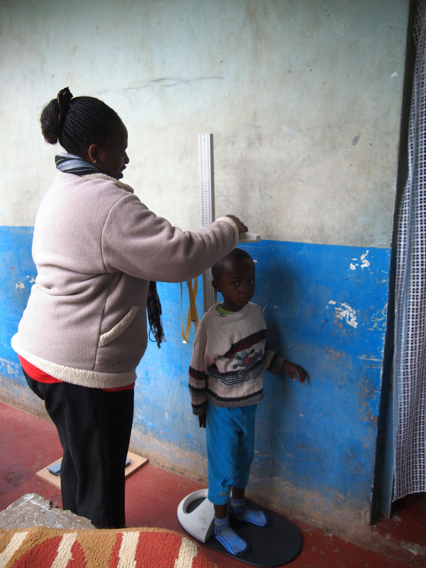 Child Being Measured by Researcher