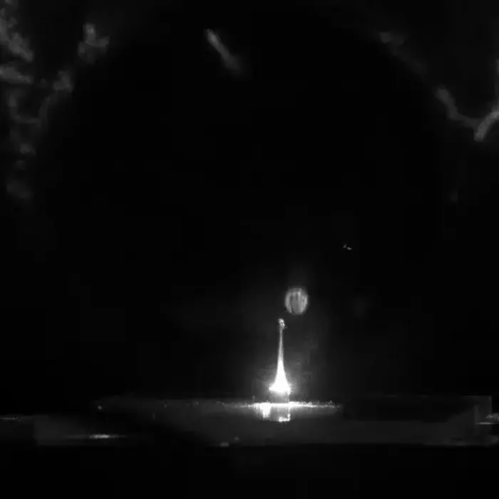 Synthesized lunar regolith in a combustion chamber