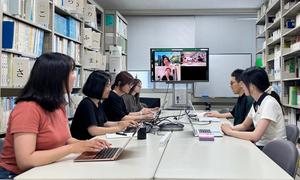 Associate Professor Yusuke Sakurai is pictured with students during class
