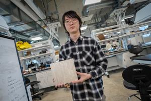 First author holding tile