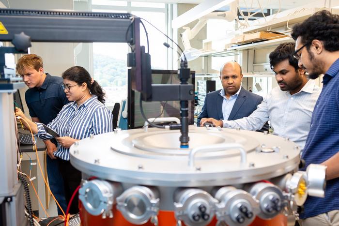 Ahmedullah Aziz and students in the lab