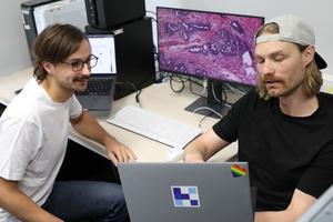 Marco Gustav (right) and MD Nic G. Reitsam (left) discuss the study data.