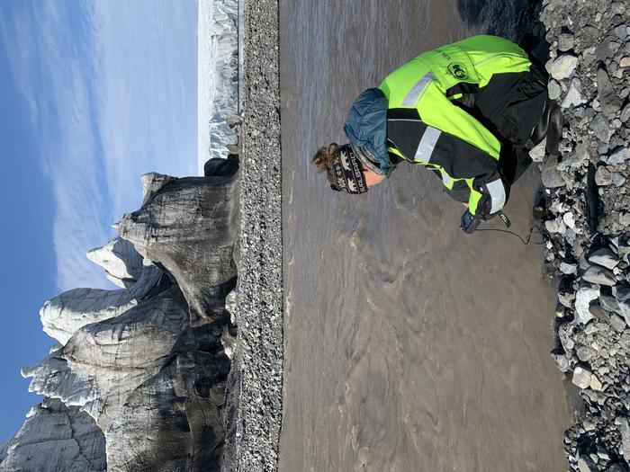 Taking hydrochemical measurements of a glacial river on Svalbard