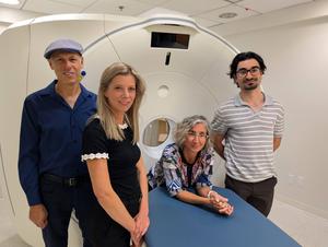Researchers with PET scanner