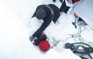 A participant is buried face down under about 50 centimeters of snow.ant is buried face down under about 50 centimeters of snow.