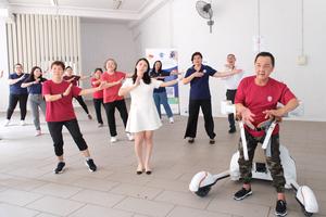 Mr Leow Cher Hwa, senior participant and stroke survivor, using the DRBA robot for Zumba class