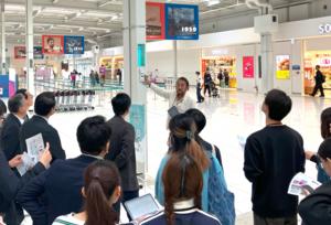 Nagahiro explains the verification experiment for the AI smart air conditioning system during a tour at Kansai International Airport