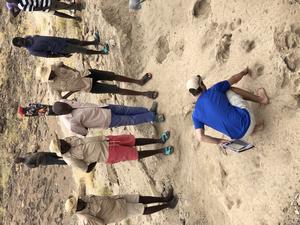 Study lead Kevin Hatala pointing out footprints of hominins.