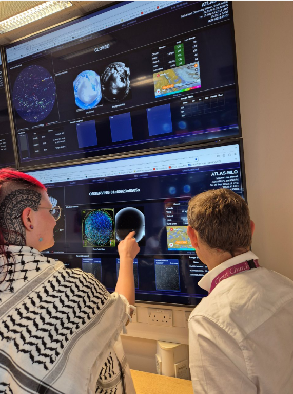 Dr Heloise Stevance and Professor Stephen Smartt with the Asteroid Terrestrial Impact Last Alert System (ATLAS), in the Astrophysics Data Lab, University of Oxford. Credit: Caroline W