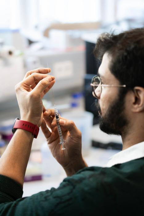Suyash Naik prepares syringe