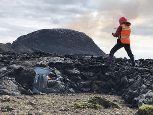 Solange Duhamel climbs onto a freshly cooled lava flow to collect samples.