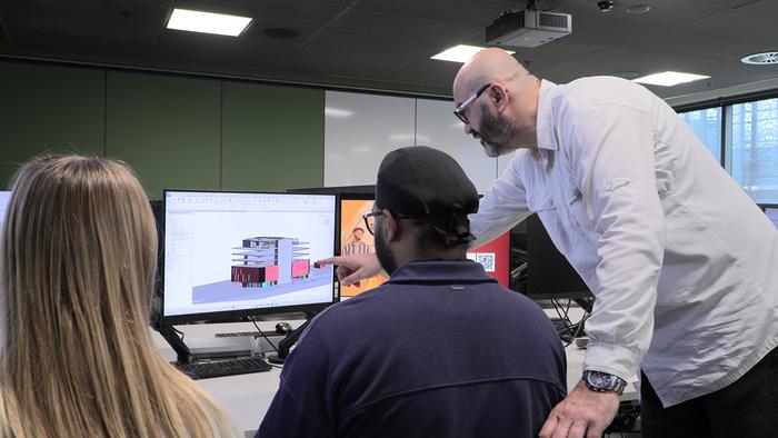 Dr Vasilios Papastamoulis and students Jennifer Rose and Ikramjit Bhalla at work with the software