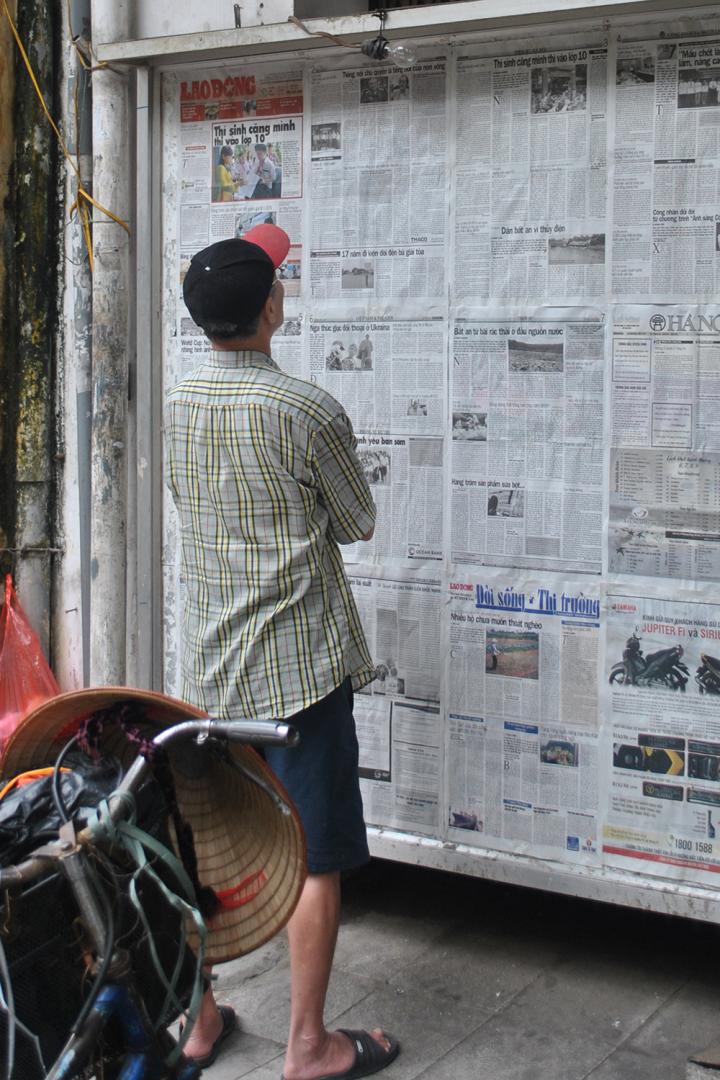 Reading a Paper in the Street