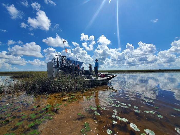 Scientists in boat in Everglades