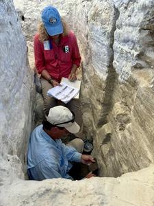 Kathleen Springer and Jeffrey Pigati collect samples for environmental change analysis from a trench in the White Sands playa.
