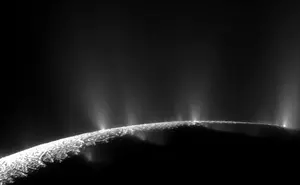 Plumes of water vapour and dust stream through cracks in the icy surface of the southern hemisphere of Enceladus.