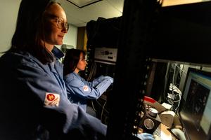 Elizabeth Plunk, PhD (left), an alumna of the Toxicology graduate program and Neuroscience graduate student Alexis Feidler (right) use a confocal microscope in the Majewska Lab at the University of Rochester Intellectual and Developmental Research Center.