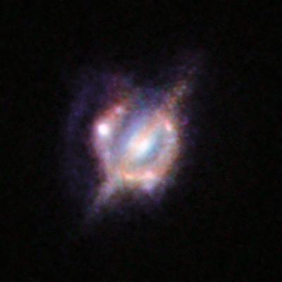 Merging Galaxies in the Distant Universe through a Gravitational Magnifying Glass