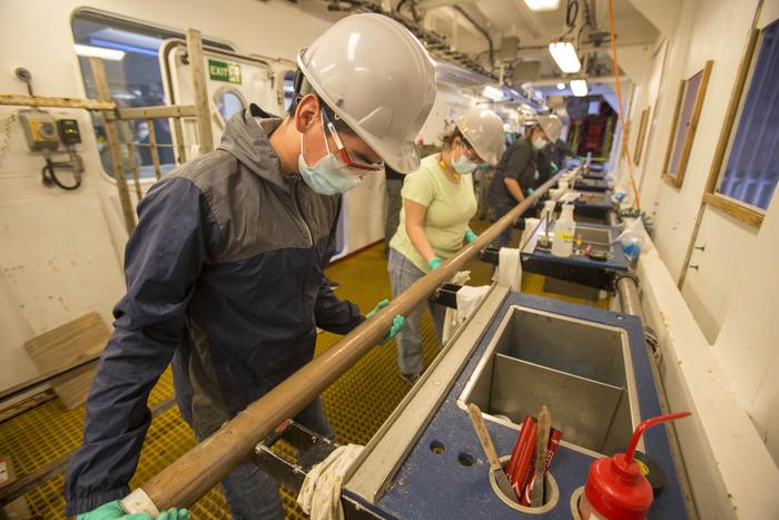 Scientists collecting sediment core on board JOIDES Resolution