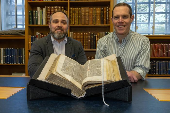James Wade and Seb Falk with Peterhouse MS 255 (wide shot)