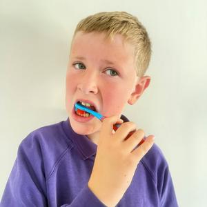 Fredi Kilgallon, aged 11, brushing teeth