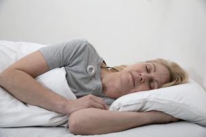 Woman sleeping with subcutaneous electroencephalography (sqEEG) system