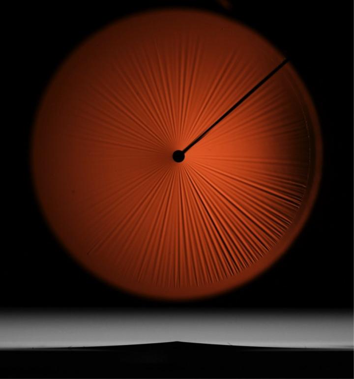 A Thin Floating Film Being Poked from Underneath