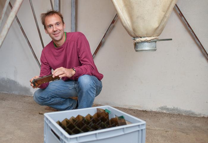 Scientist Emanuel Heitlinger with the mouse traps he uses for his research on farms