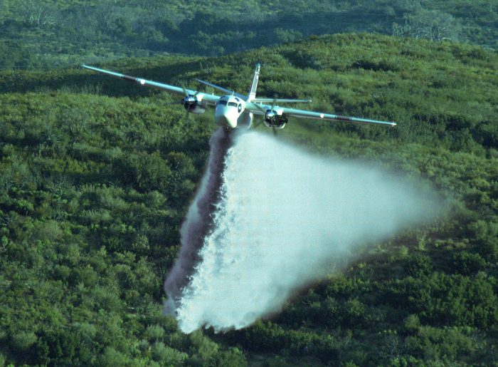 Airplane spraying a forest (colors have been changed).