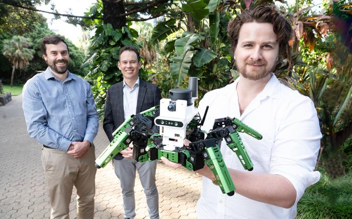 Dr Adam Hines and his green robot