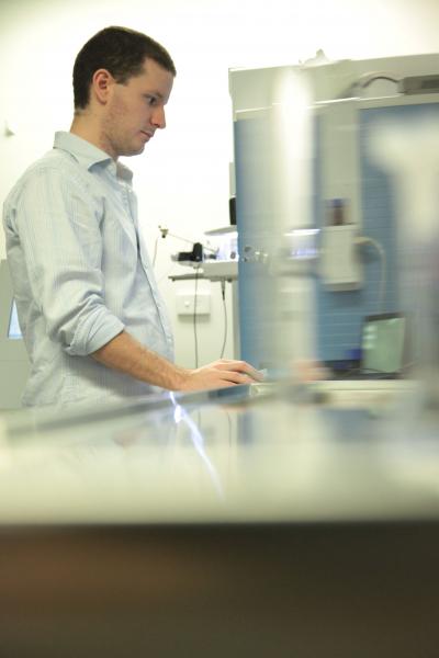 Ph.D. Student Sean Humphrey Working on a Mass Spectrometer (2 of 2)