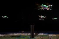 The Gripper Drone Controlled by a Player, Picking up a Tube Which is Guarded by 3 Other UAVs