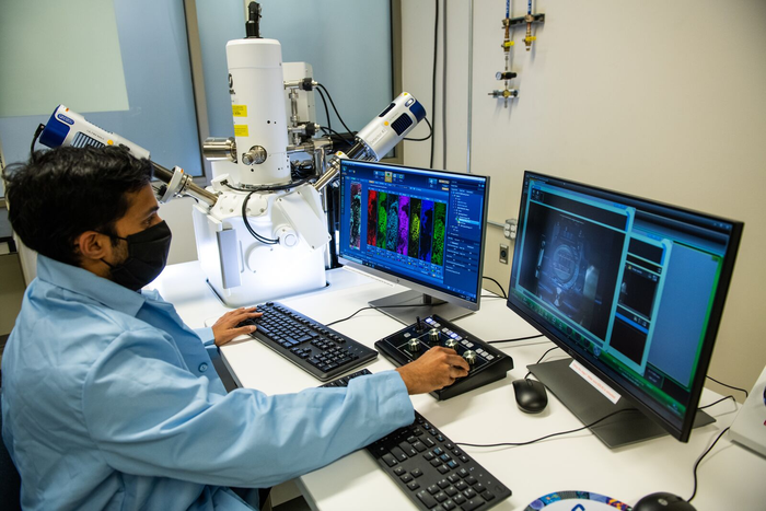 Arun Devaraj with microscopes