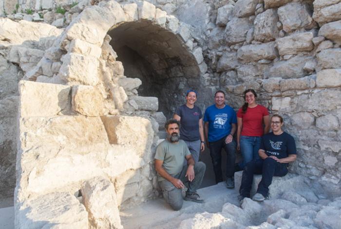 Team members in front of the vaulted ritual bath.
