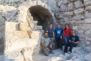 Team members in front of the vaulted ritual bath.