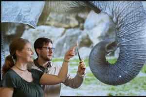 Researchers holding 3D-printed whisker