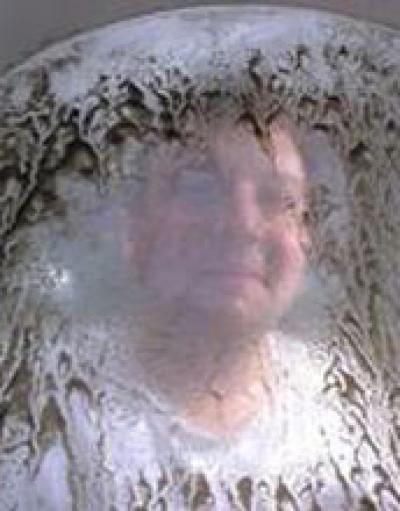 Researcher behind Screen with Oyster Larvae at the Whiskey Creek Shellfish Hatchery