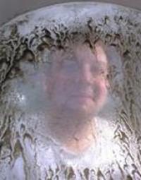 Researcher behind Screen with Oyster Larvae at the Whiskey Creek Shellfish Hatchery