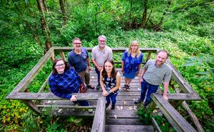 Research team stands on an observation deck overlooking a wetland