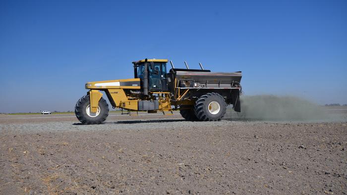 Spreader Unloads Crushed Rock