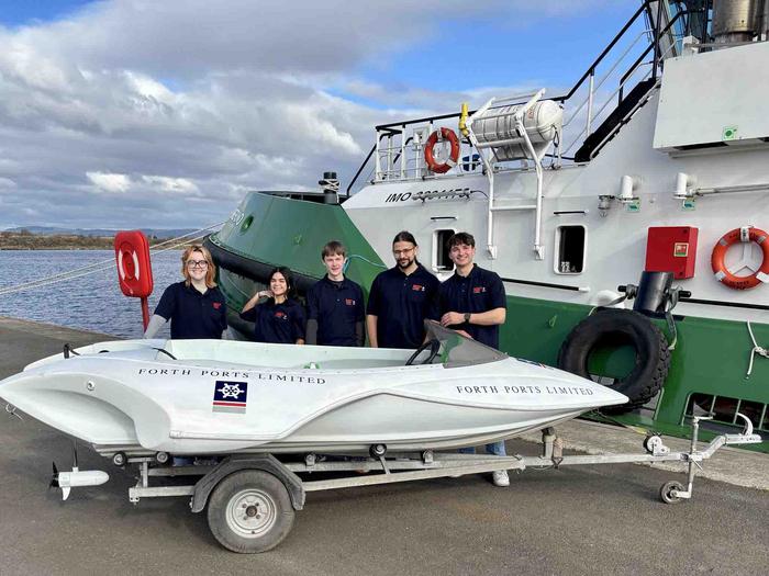 Group shot with boat