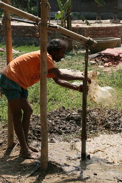 Worker Drilling Well