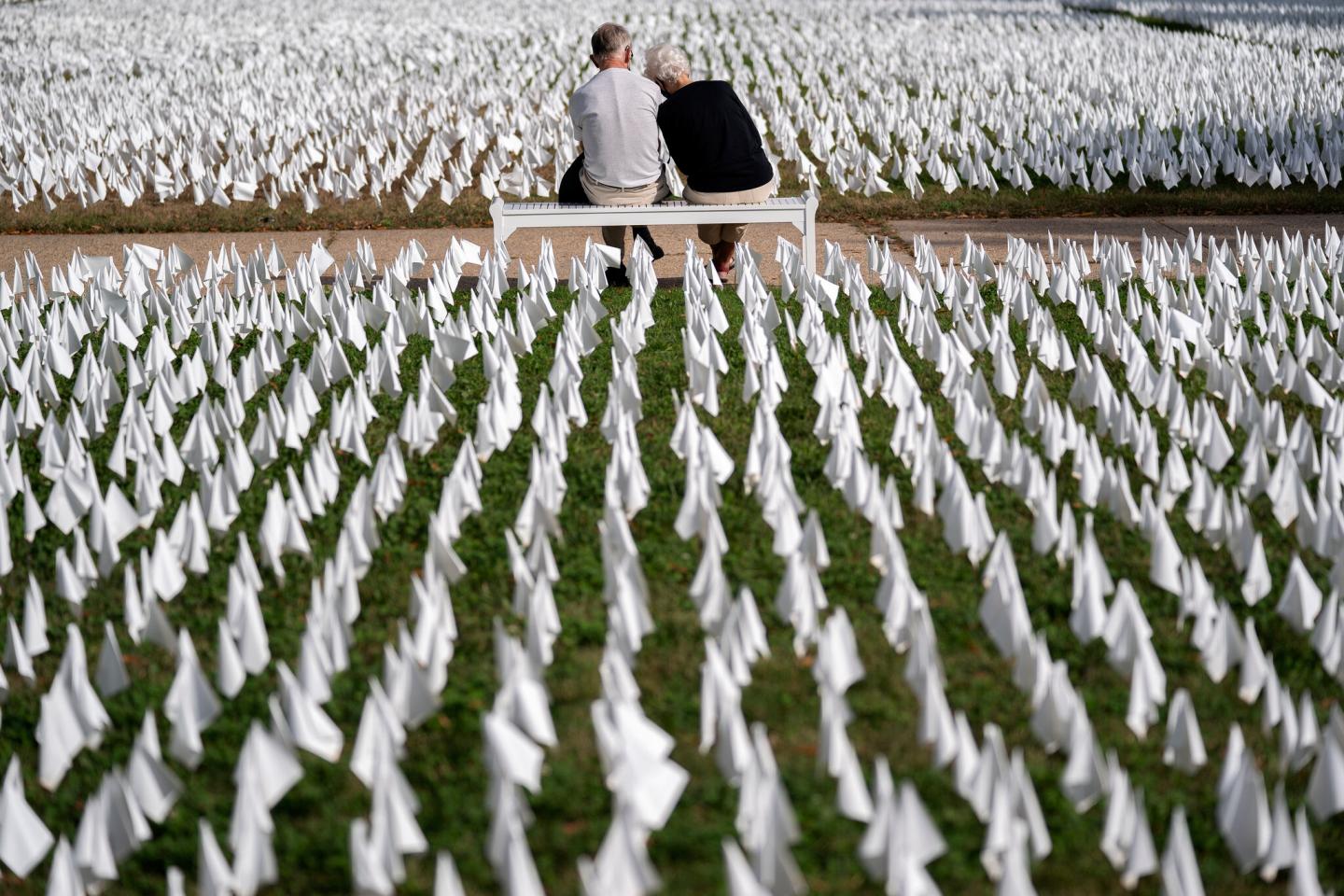 A couple visiting "IN AMERICA How Could This Happen..."