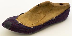 Prototype footwear mounted on a wooden last.